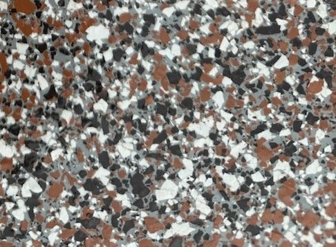 A close up of a white and brown granite counter top