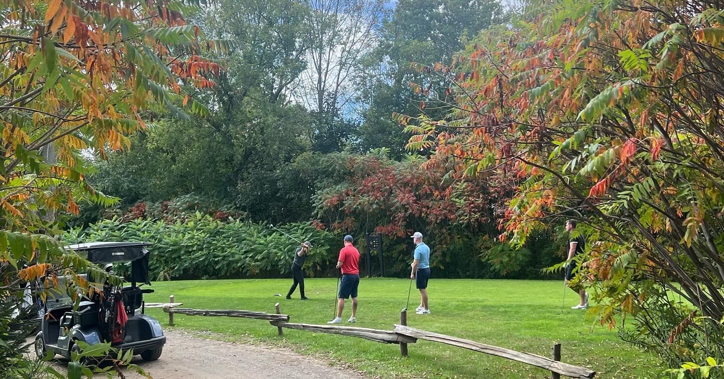 A group of people are playing frisbee in a park.