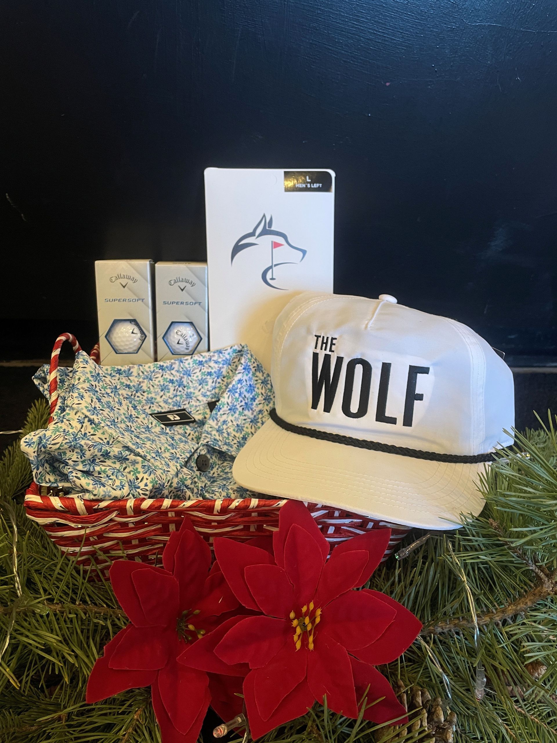 A golf club is sitting next to a golf ball on a green.