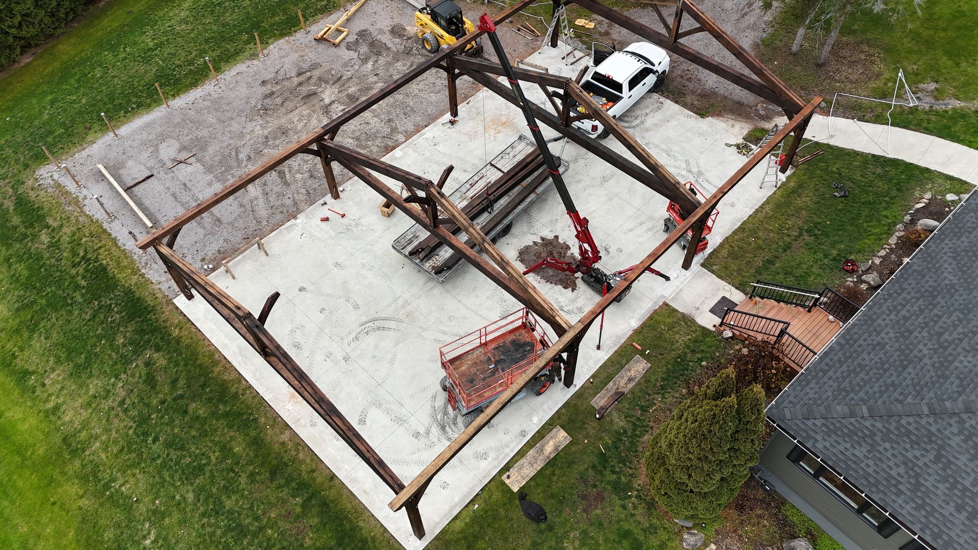 An aerial view of a golf course surrounded by trees and a river.