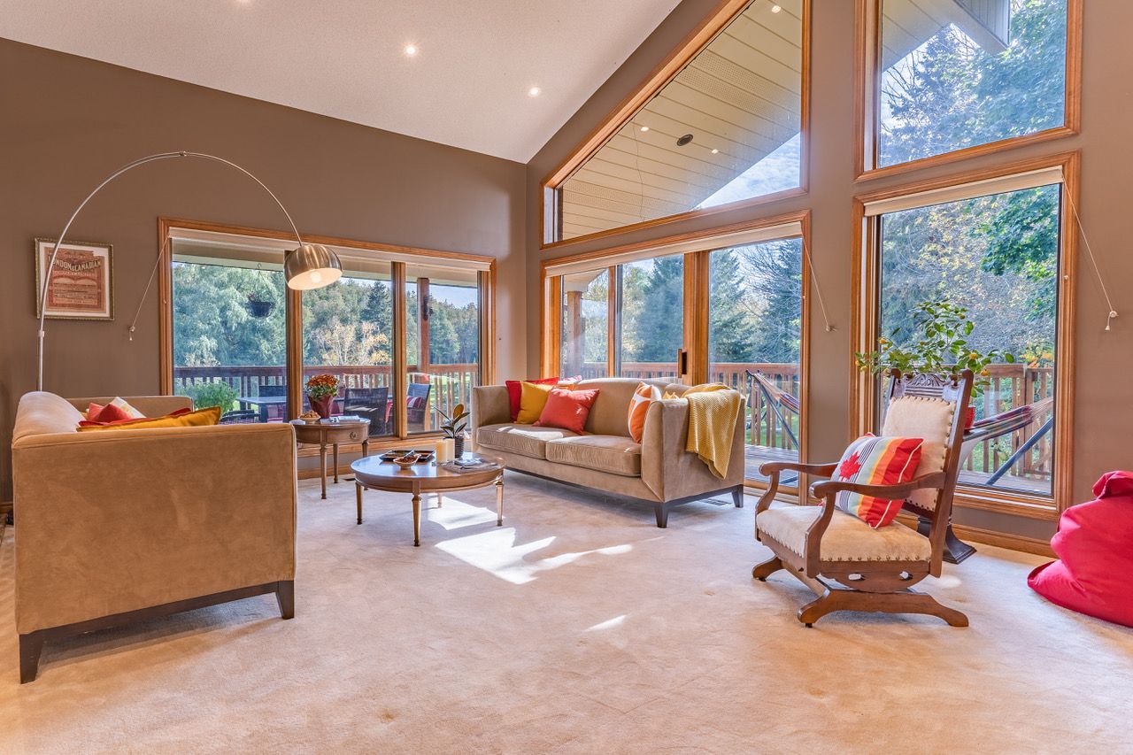 A living room filled with furniture and lots of windows.
