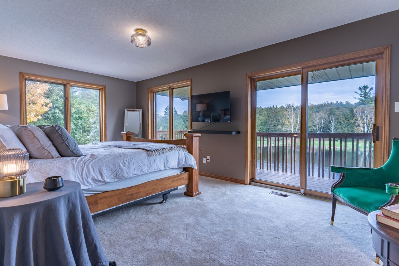 A bedroom with a bed , chair , table and television.