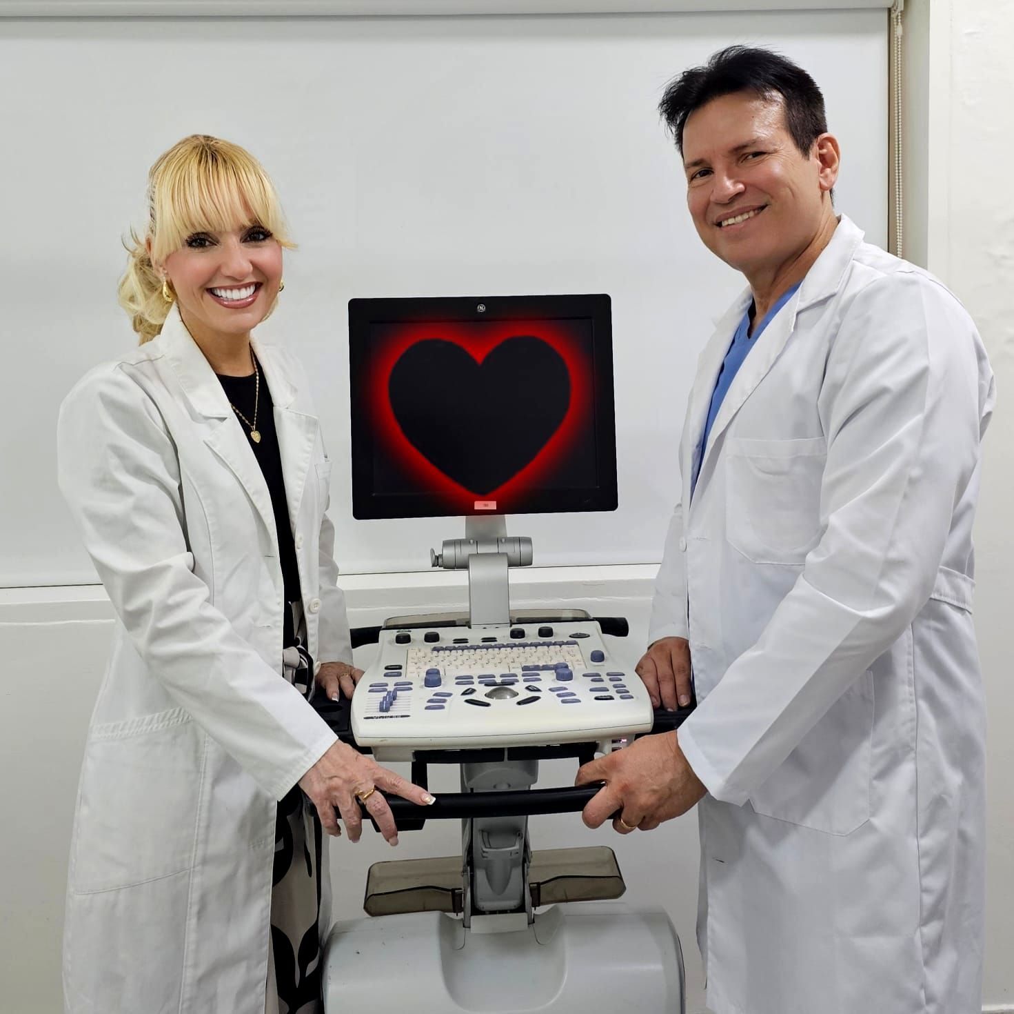 A man and a woman standing next to an ultrasound machine