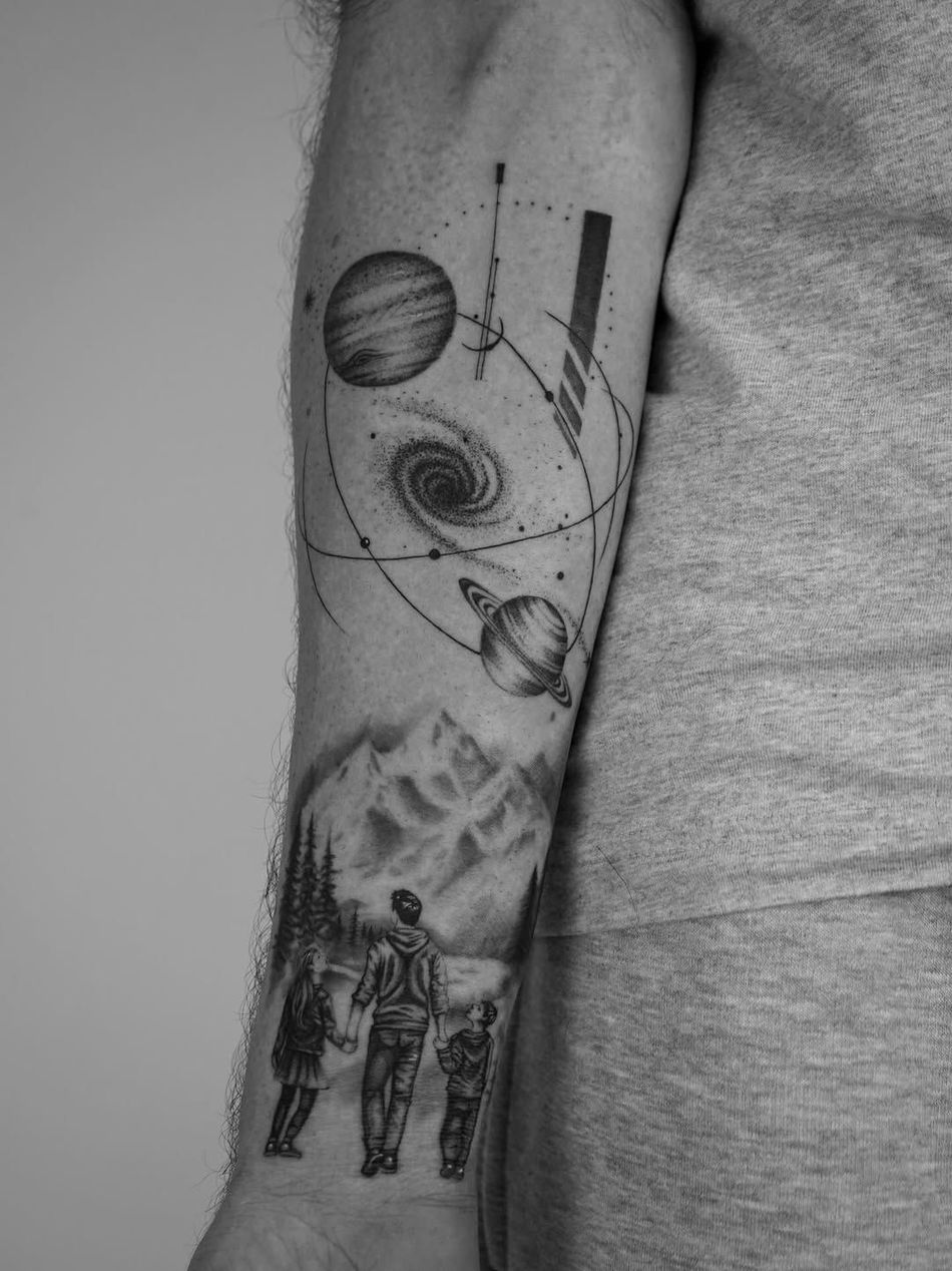 A black-ink tattoo on skin featuring a sun and moon phases above a scale weighing a heart against a brain.