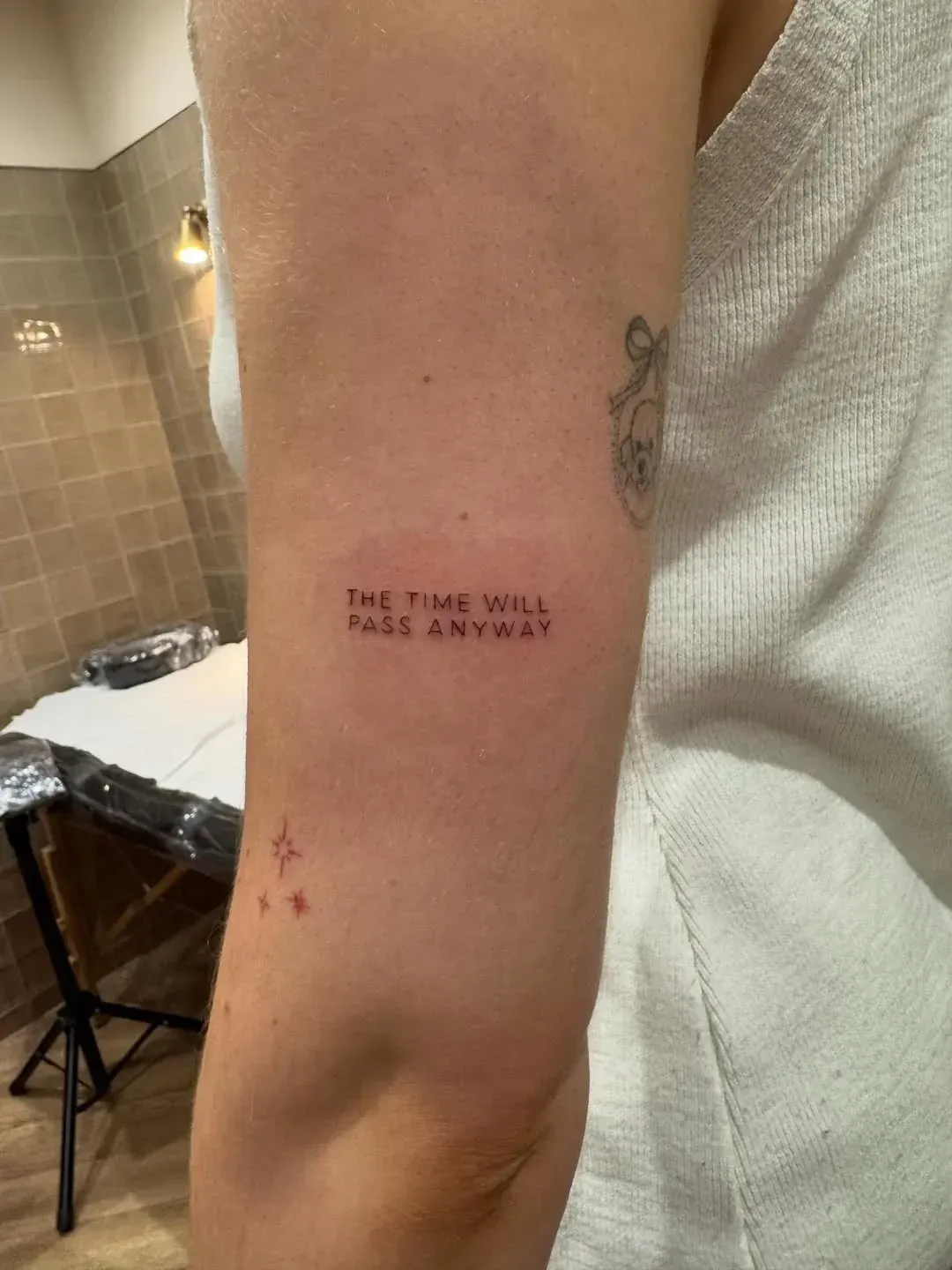 A small tattoo on an arm that reads 