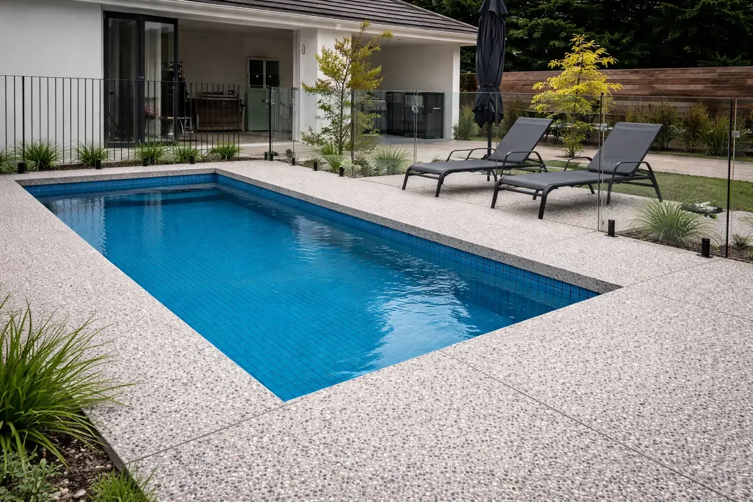 Rectangular pool with exposed aggregate concrete pool surround in Kelso Townsville