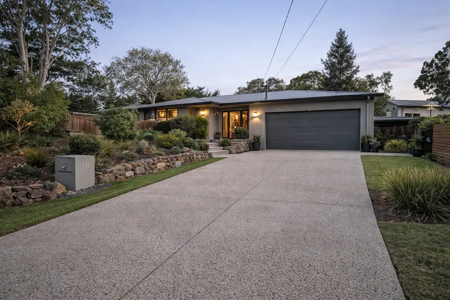 Concrete aggregate driveway, and landscaped rock garden in Townsville.