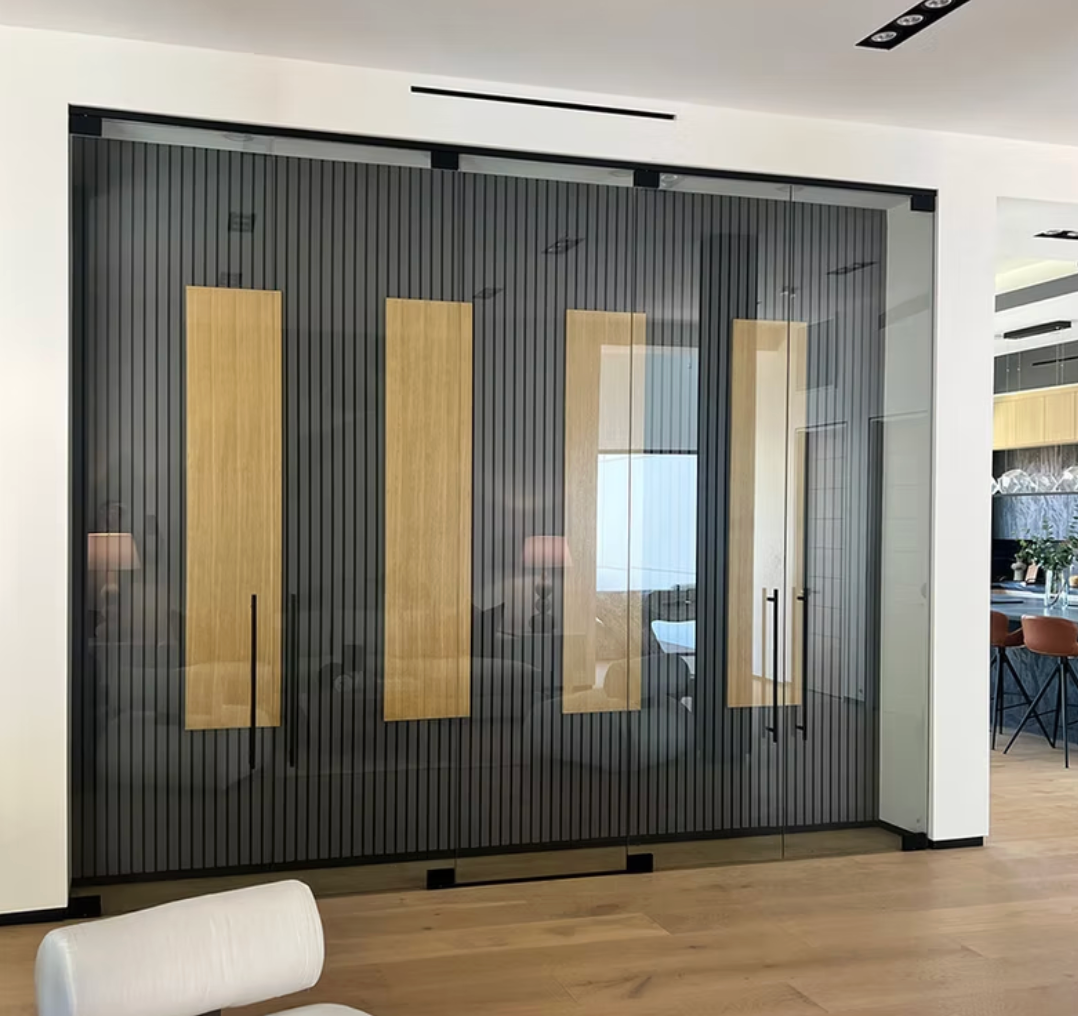 Glass sliding doors with wood panels and handles, in a modern living space.