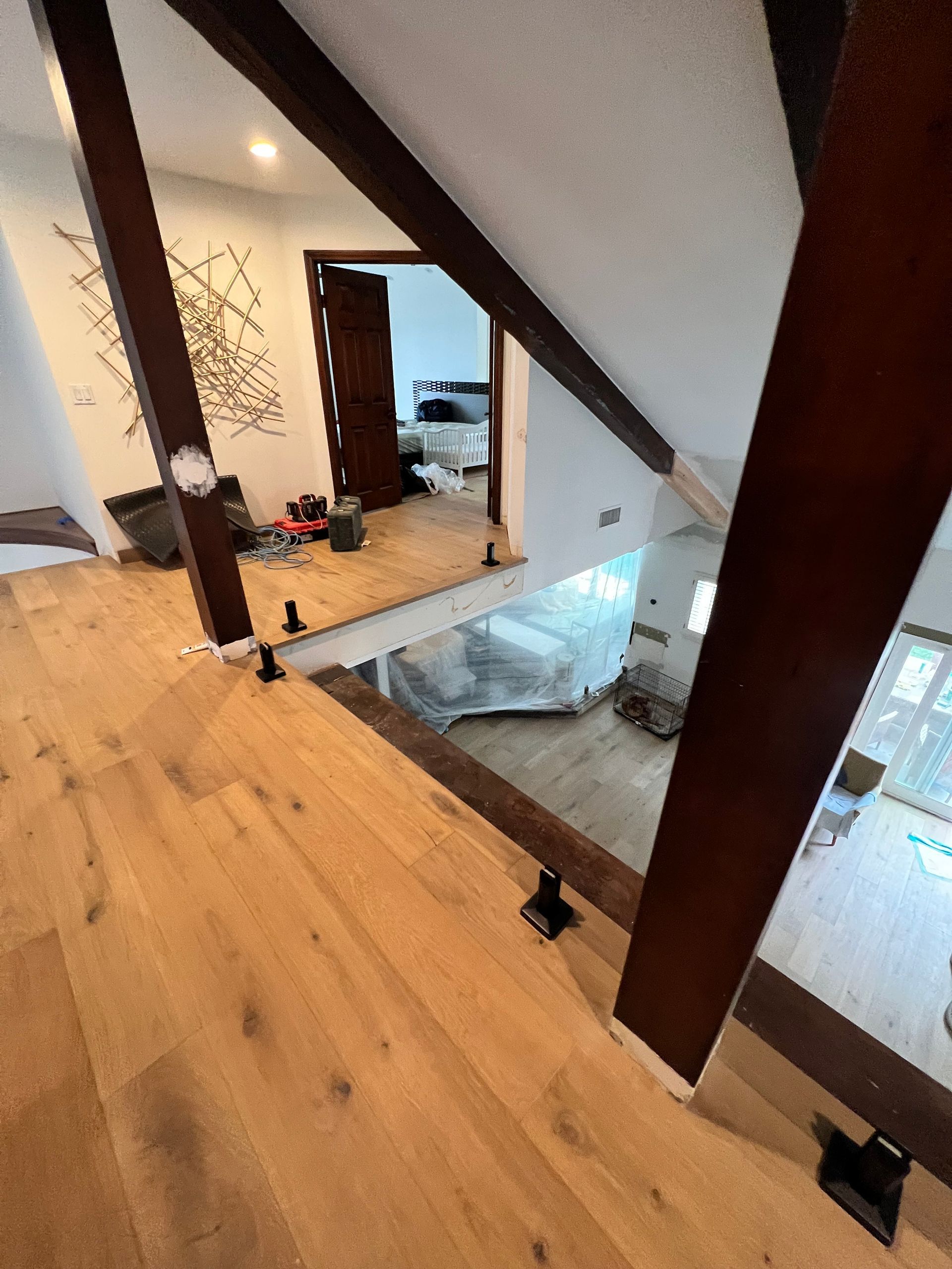 Wooden beams and floor in a house under construction; view of rooms and doorways.