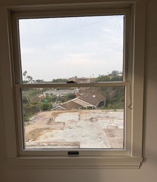 Glass sliding doors with wood accents. Dark gray background with gold rectangles. Black hardware.