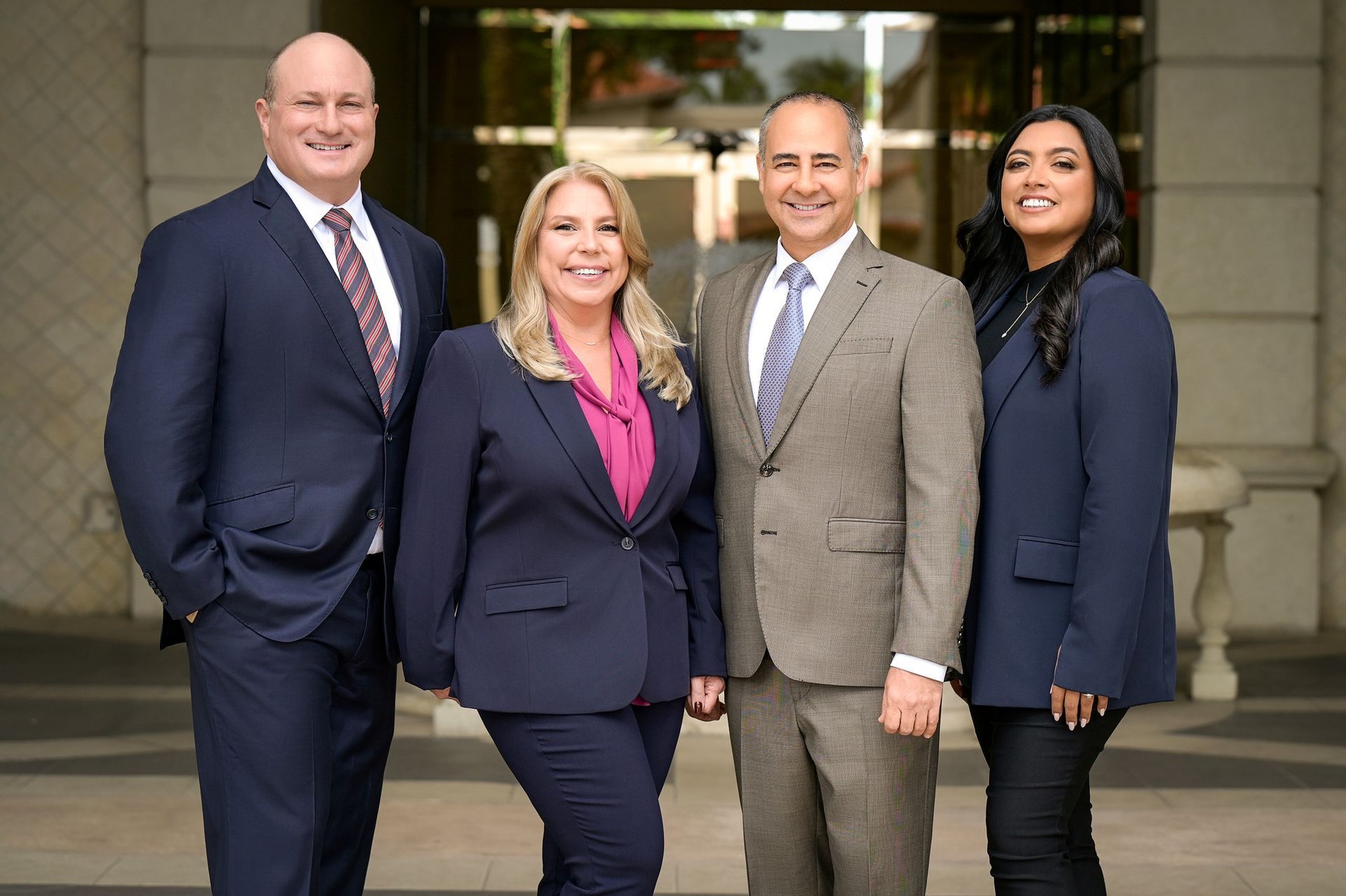 A group of people in suits and ties are posing for a picture.