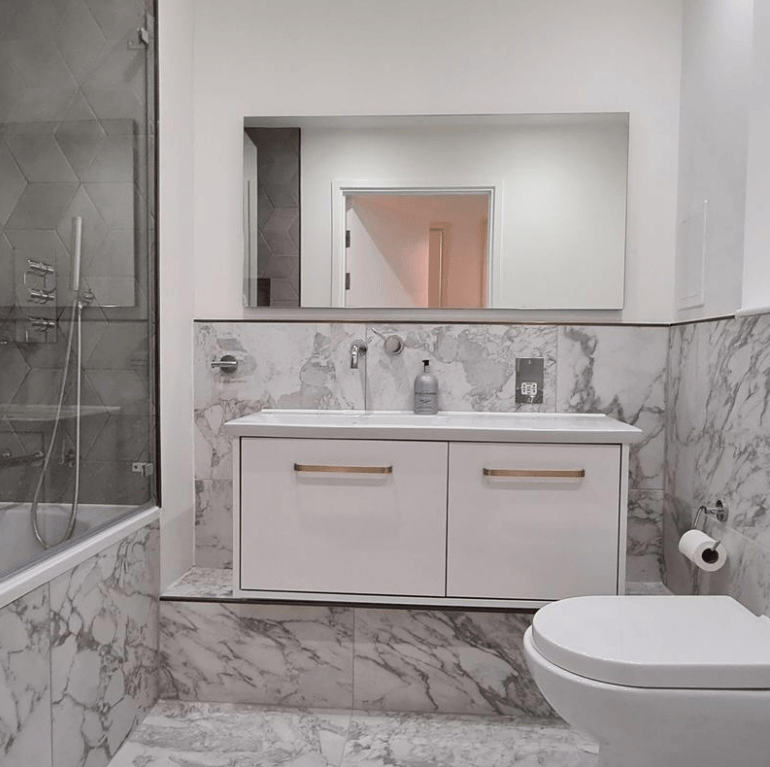 Picture of a new white and marble bathroom fitted by plumbers sheffield