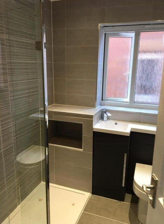 Picture of a new bathroom with walk in shower and vanity unit installed by Plumbers Sheffield