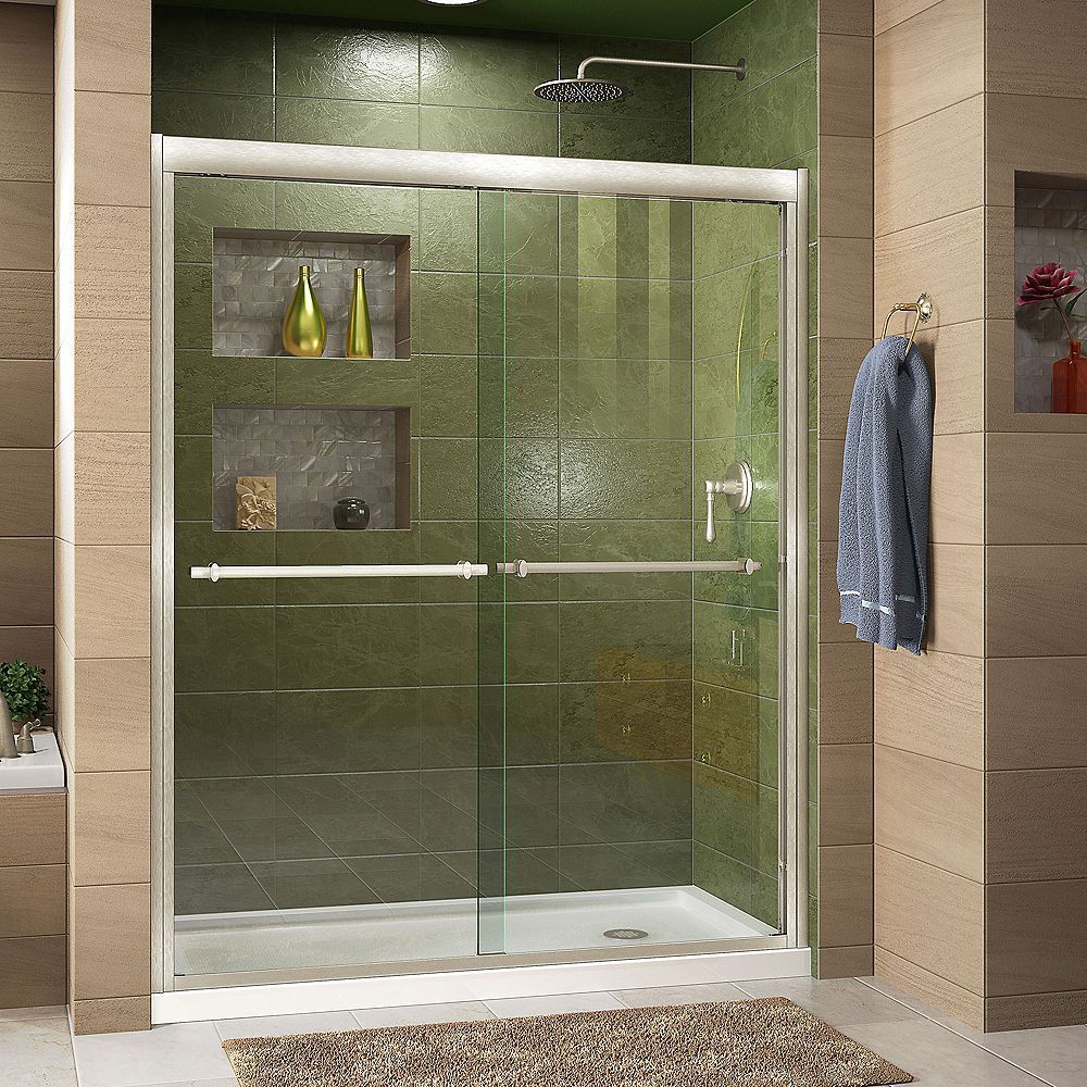 A bathroom with a sliding glass shower door