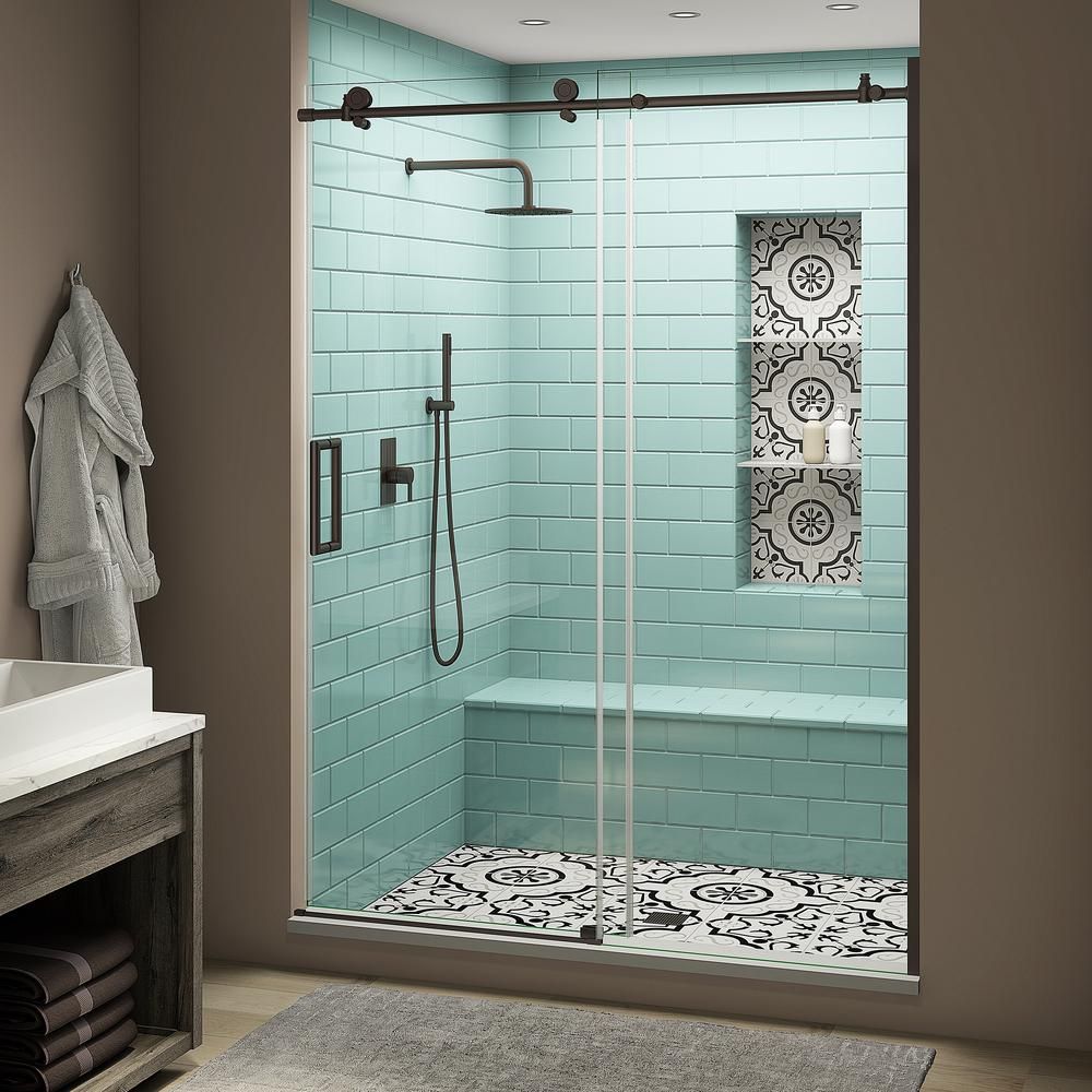 A bathroom with blue tiles and a sliding glass shower door.