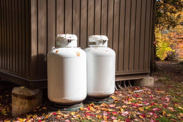 Two white propane tanks at the back of a metal hut