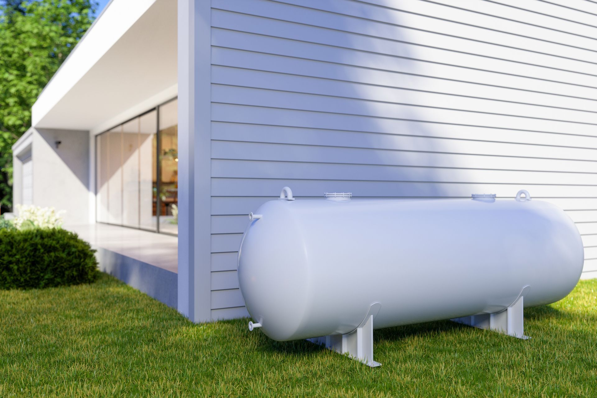 Exterior of a white villa with a propane gas tank in the backyard.