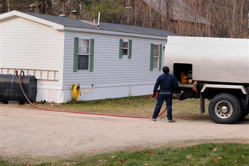 A delivery man offering propane tank delivery services from Yavapai Bottle Gas fuel to a countryside