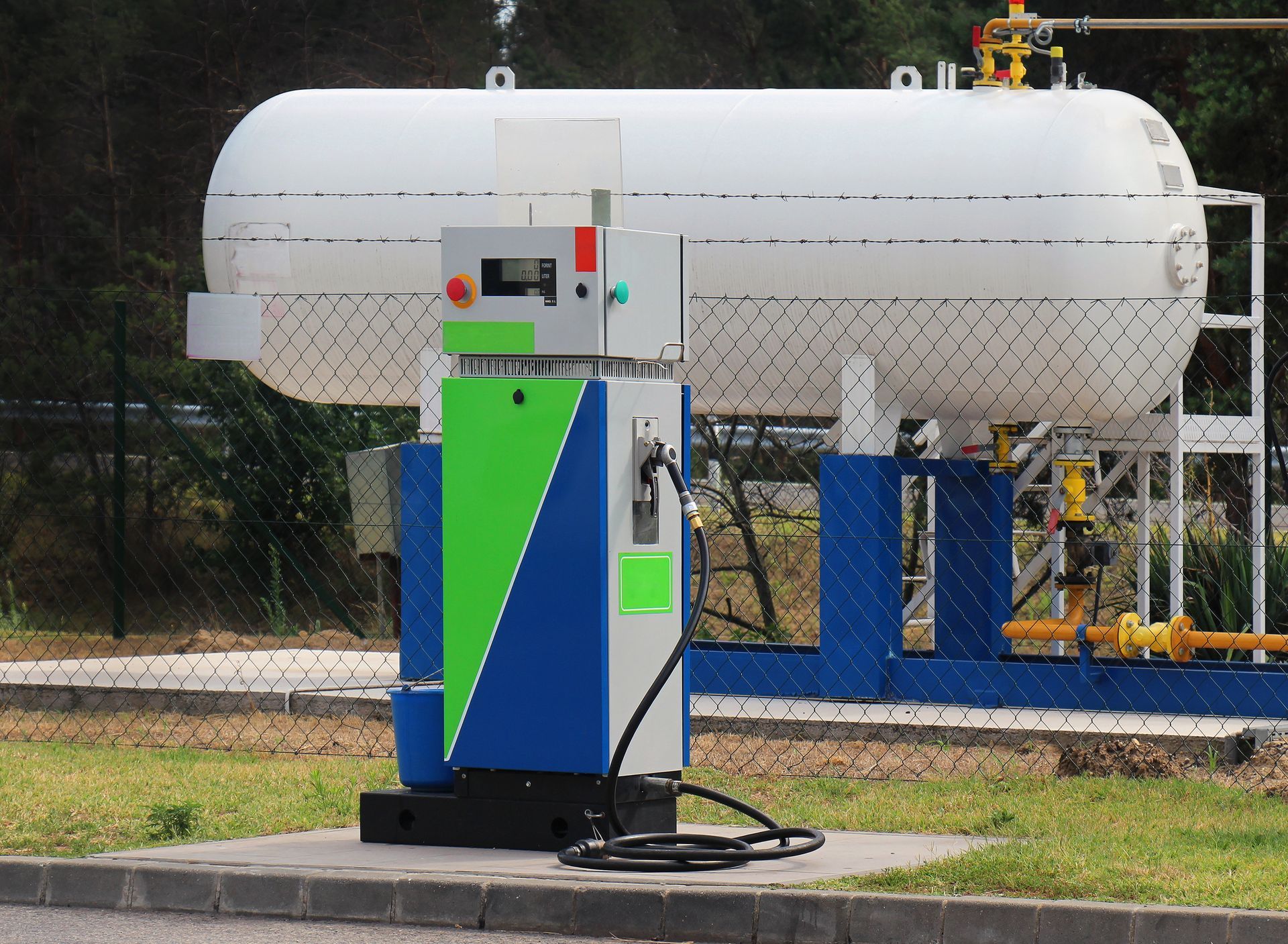 A gas station next to a white tank