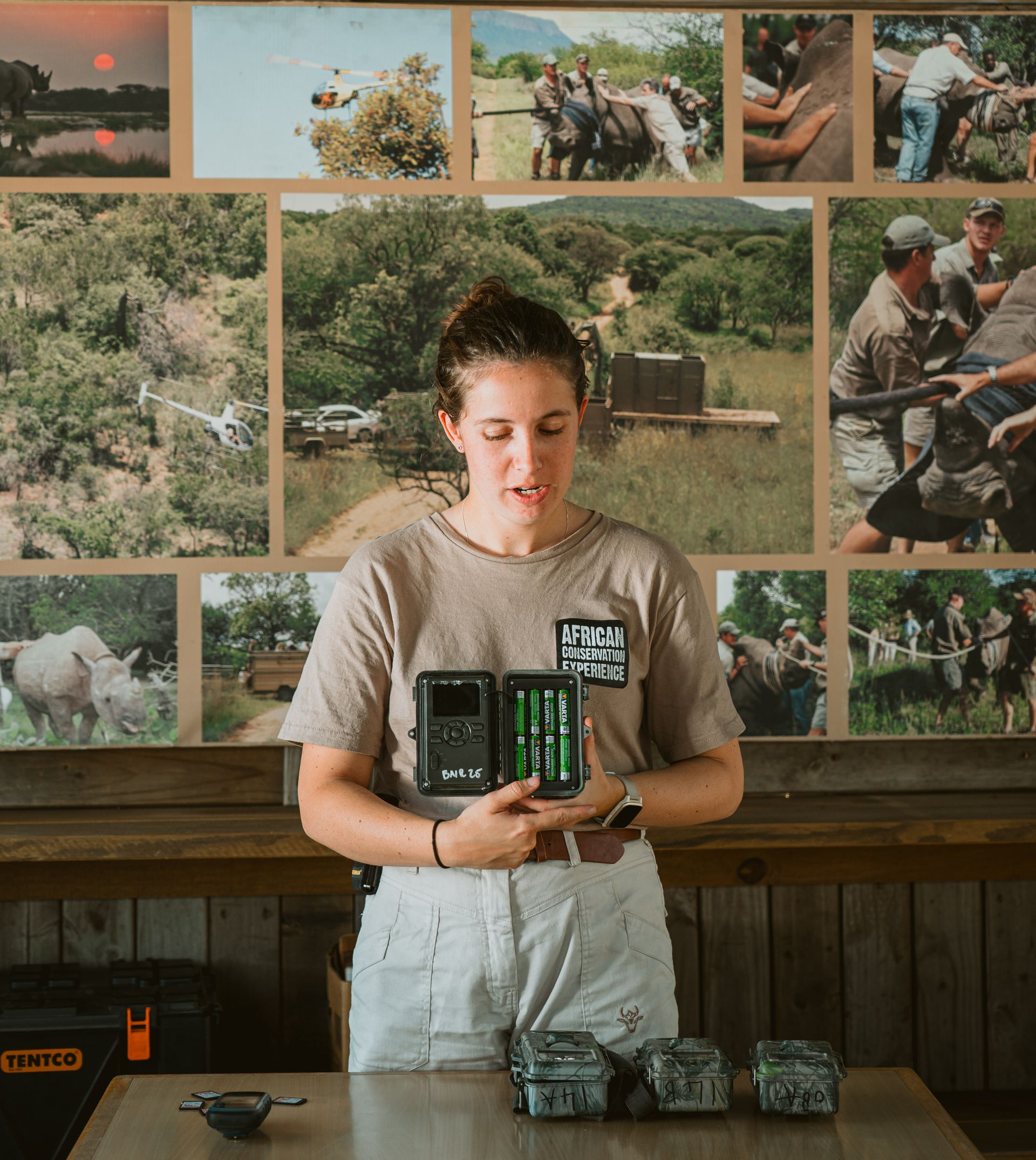 Khanya Conservation Camp sign on a tan building. Covered porch with lounge chairs visible.