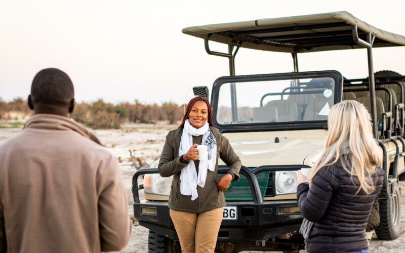 Bundox guests on safari near a safari vehicle. Breakfast break
