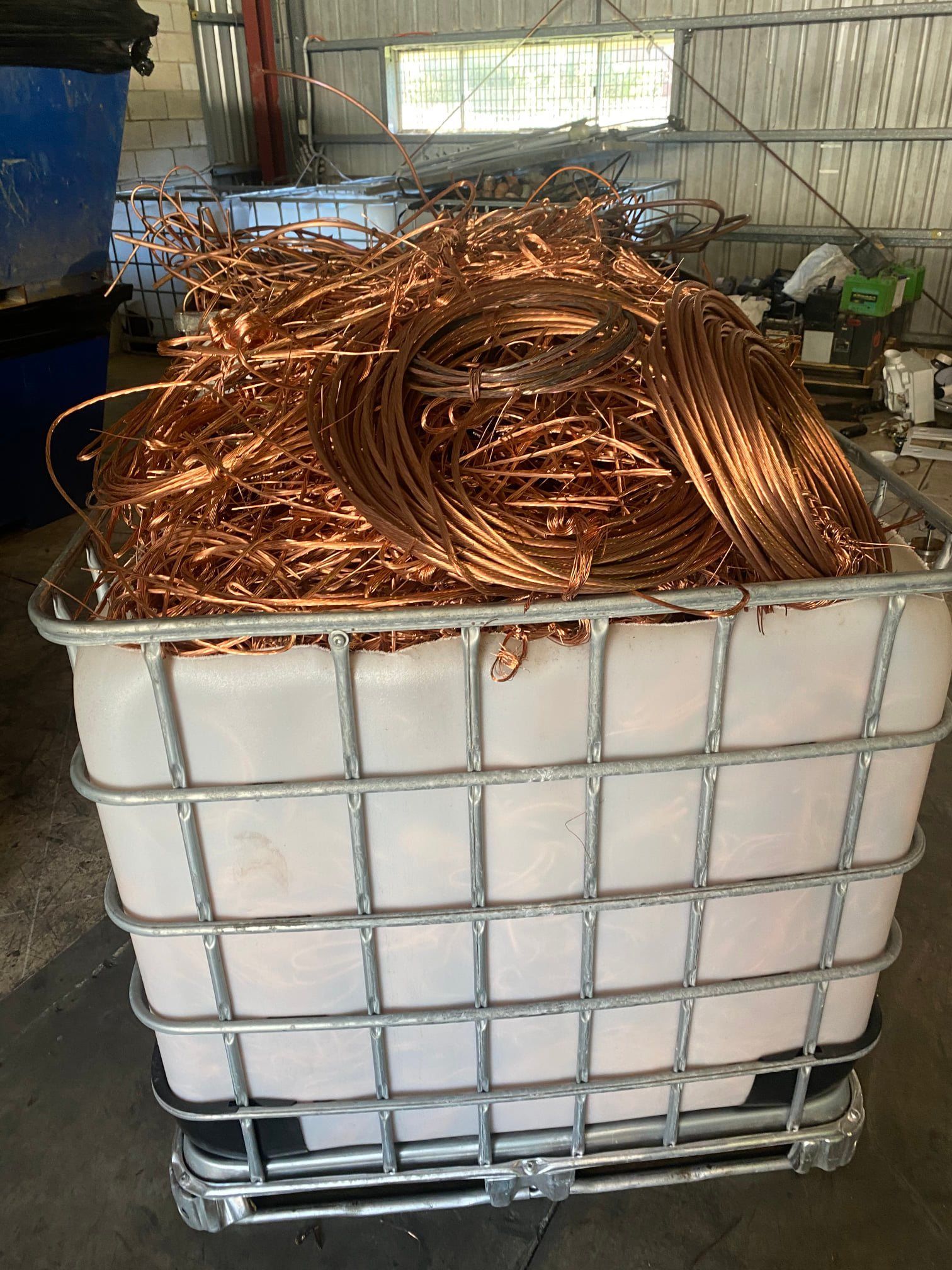 Copper Wire Scrap In A White Container With A Metal Cage, In A Warehouse Setting — H&H Metal Recycling in Kenilworth, QLD