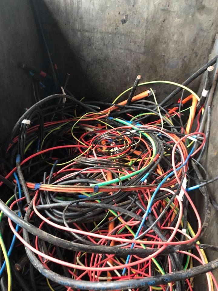 Tangled Pile Of Colorful Electrical Wires Inside A Gray Container — H&H Metal Recycling in Moffat Beach, QLD