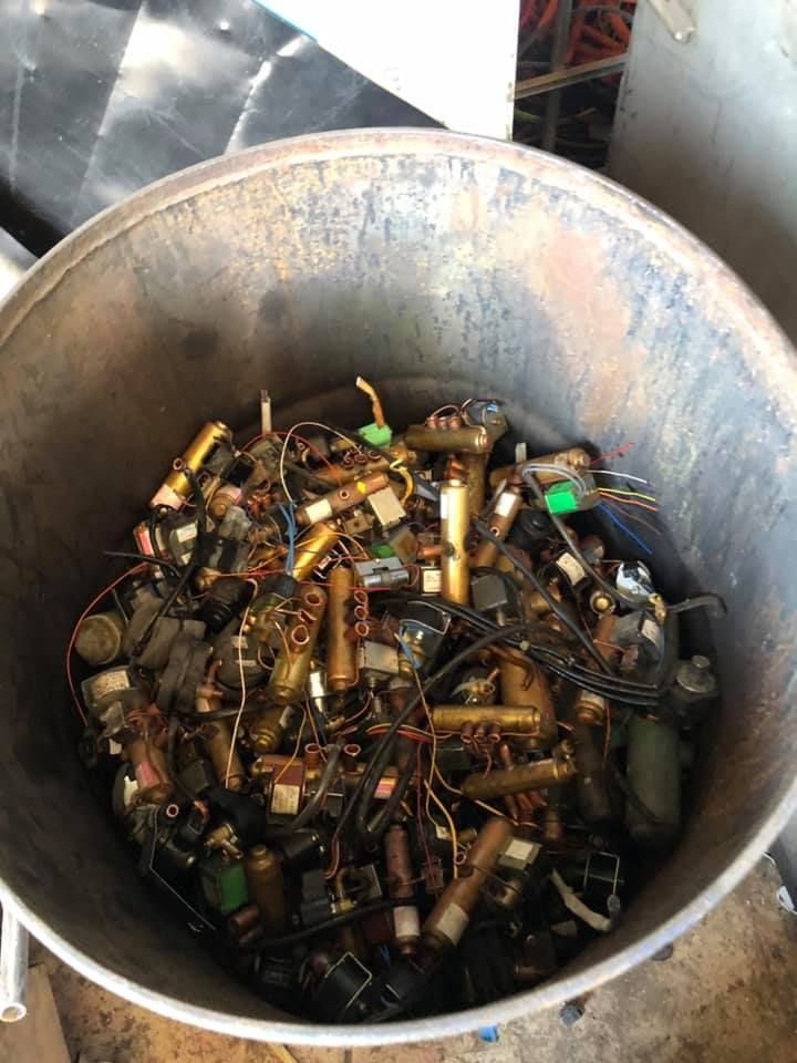 A Metal Barrel Filled With A Pile Of Brass-colored Solenoid Valves — H&H Metal Recycling in Maleny, QLD