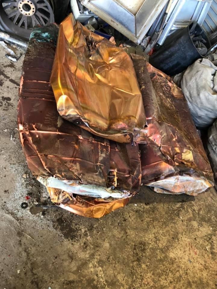 Pile Of Flattened Copper Sheets On A Concrete Floor — H&H Metal Recycling in Maleny, QLD