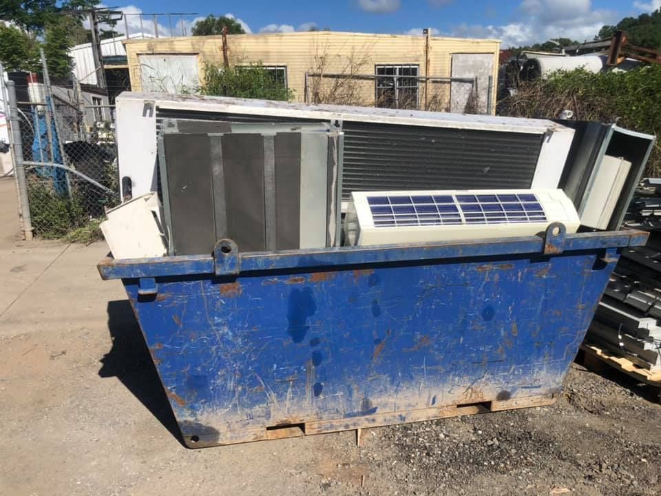 Blue Dumpster Filled With Scrap Metal And Appliances — H&H Metal Recycling in Pelican Waters, QLD