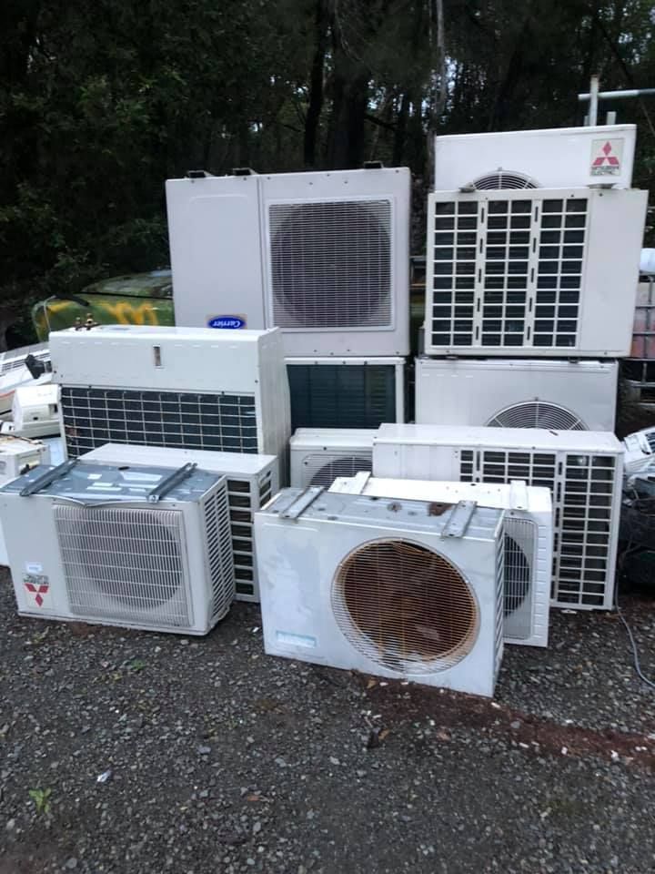 Pile Of White Air Conditioning Units In A Yard, Some With Visible Grates — H&H Metal Recycling in Pelican Waters, QLD