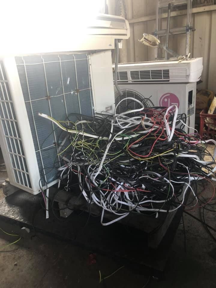 Pile Of Colorful Wires Next To An Air Conditioning Unit — H&H Metal Recycling in Pelican Waters, QLD