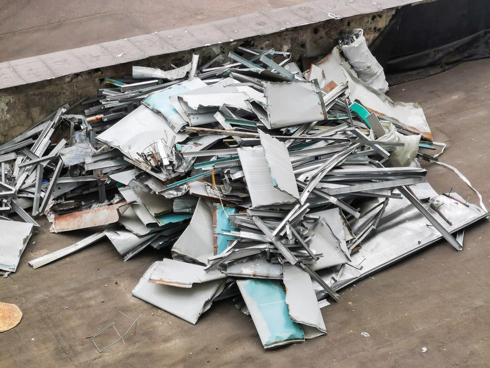 A Pile of Scrap Metal Is Sitting on The Ground — H & H Metal Recycling In Coolum, QLD