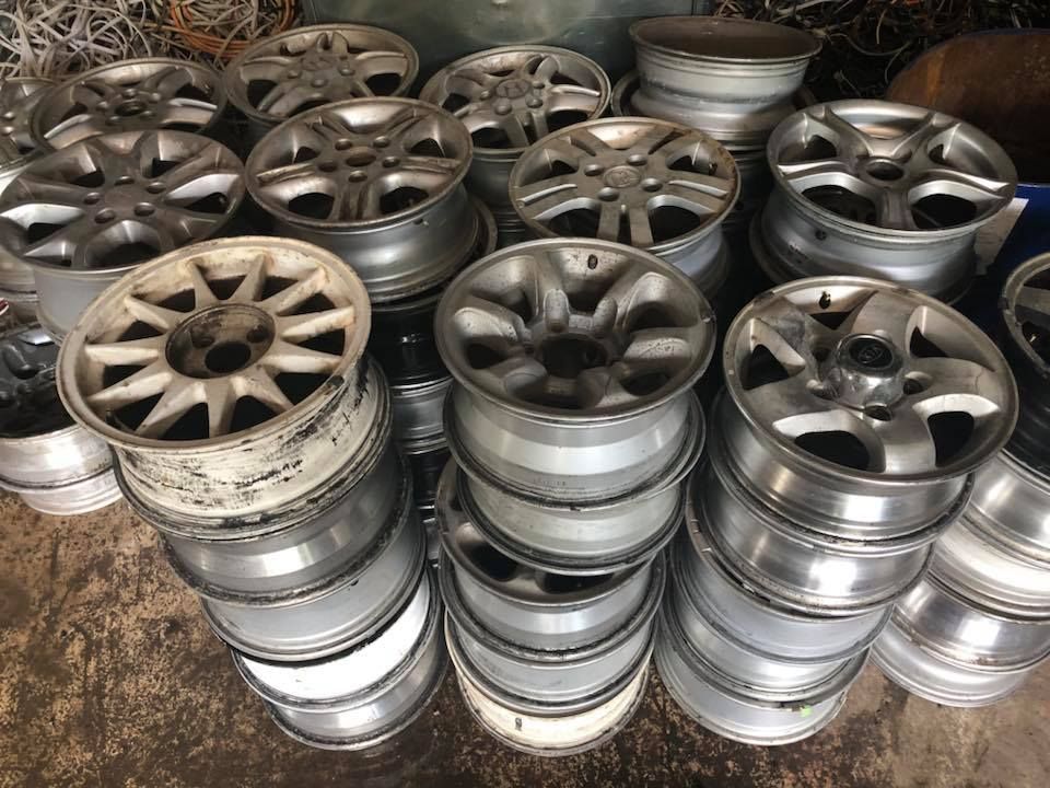 Pile Of Used Silver Car Rims, Stacked In A Possibly Industrial Setting — H&H Metal Recycling in Bells Creek, QLD