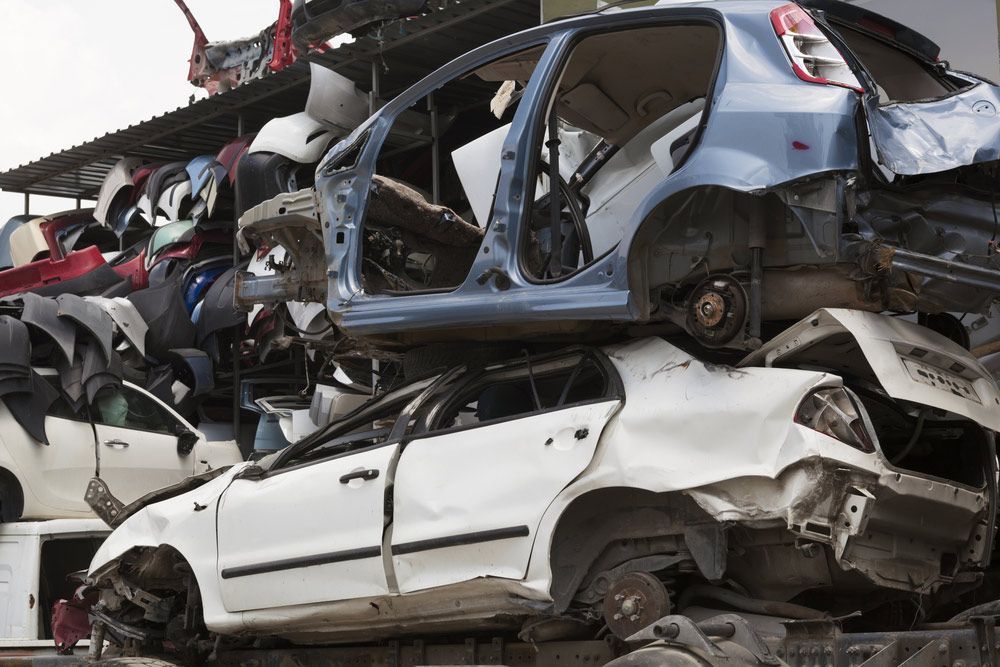 A Pile of Wrecked Cars Are Stacked on Top of Each Other — H & H Metal Recycling In Coolum, QLD