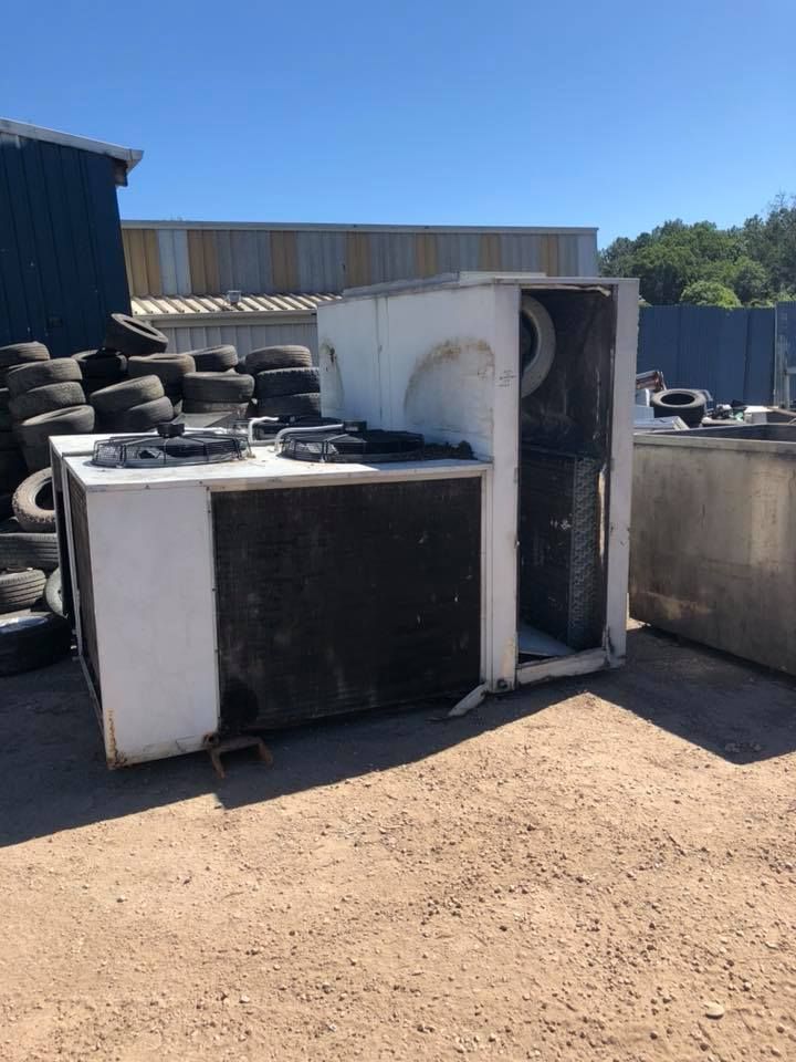 A White Industrial Refrigeration Unit On A Gravel Surface — H&H Metal Recycling in Mudjimba, QLD