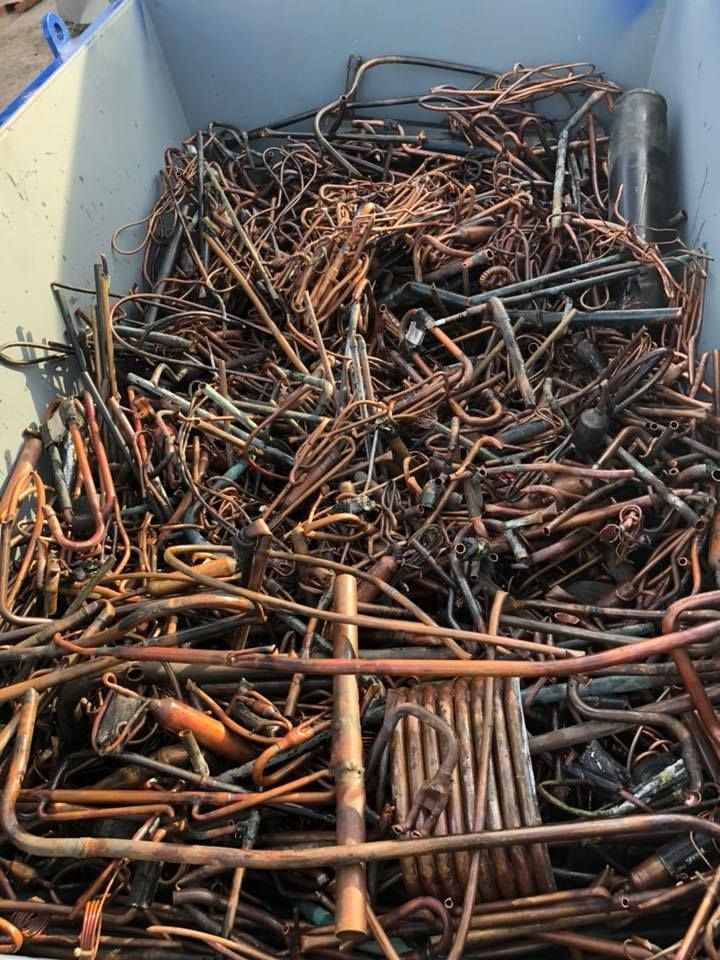 A Pile Of Scrap Copper Tubing, Wires, And Parts In A Blue Container — H&H Metal Recycling in Mudjimba, QLD