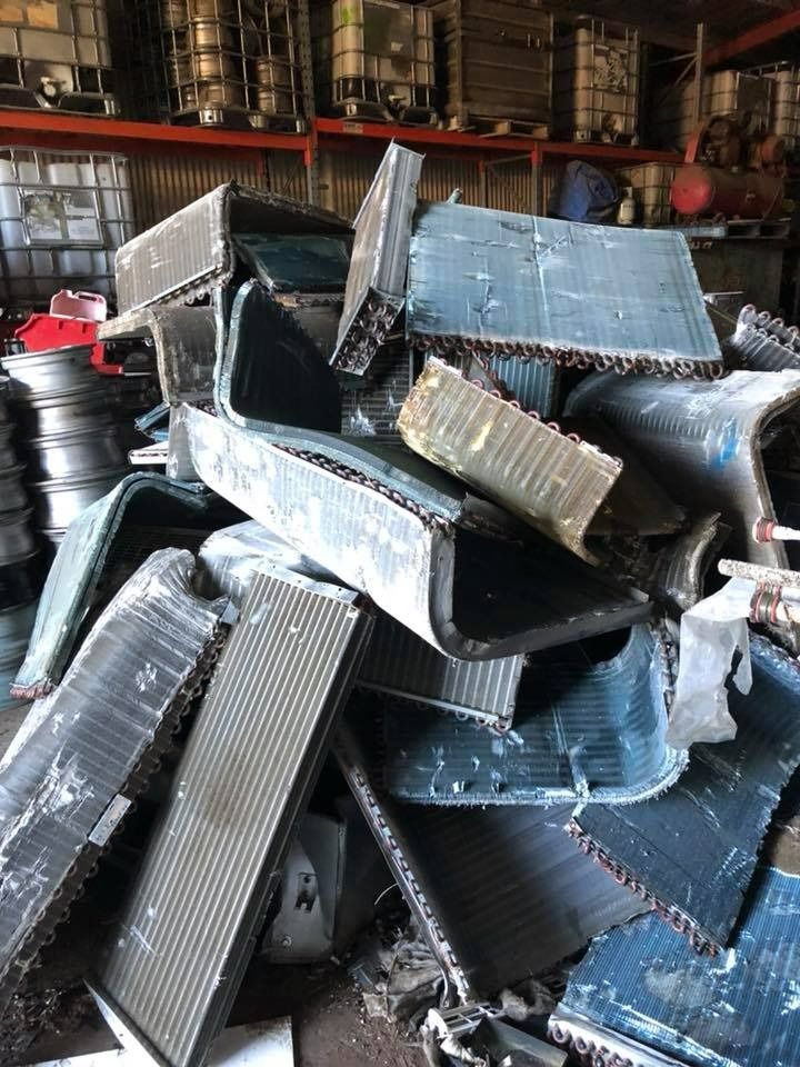 A Pile of Scrap Metal Is Stacked on Top of Each Other in A Warehouse — H & H Metal Recycling In Maroochydore, QLD