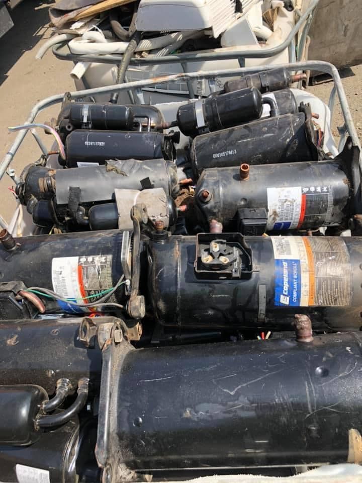 A Metal Bin Filled With Numerous Black Cylindrical Air Conditioning Compressors — H&H Metal Recycling in Beerwah, QLD