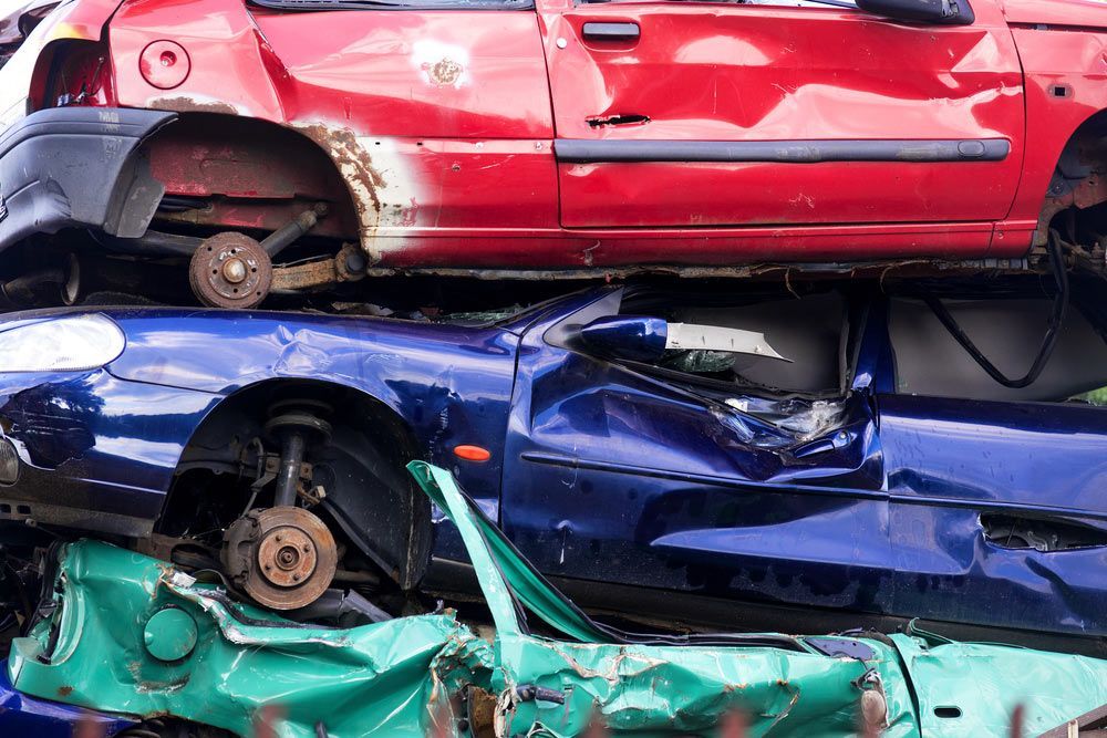 A Pile of Damaged Cars Stacked on Top of Each Other — H & H Metal Recycling In Nambour, QLD