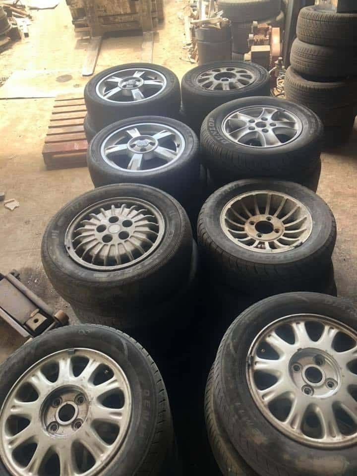 A Bunch of Tires and Wheels Are Stacked on Top of Each Other in A Garage — H & H Metal Recycling In Kawana Waters, QLD