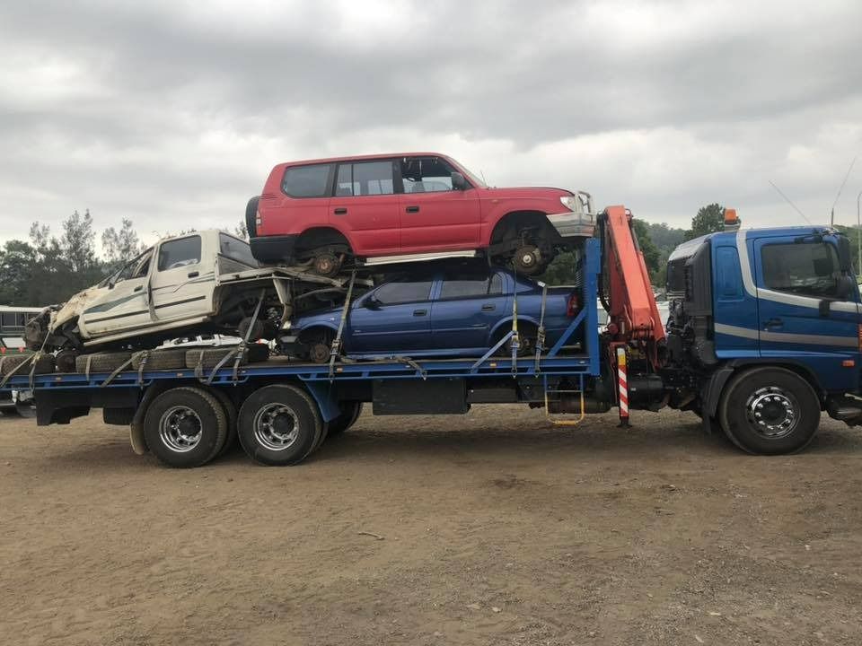 A Tow Truck Is Carrying a Stack of Cars on Top of It — H & H Metal Recycling In Caboolture, QLD