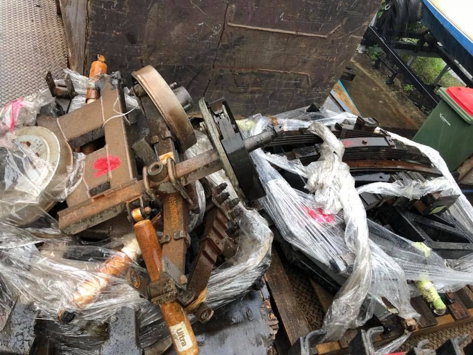Heap Of Metal Machine Parts Wrapped In Plastic, In A Dumpster — H&H Metal Recycling in Moffat Beach, QLD