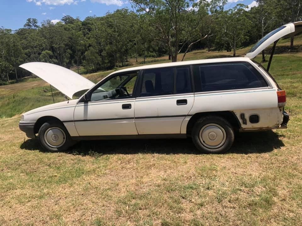 White Station Wagon With Open Hood And Hatch, Parked On Grass — H&H Metal Recycling in Glass House Mountains, QLD