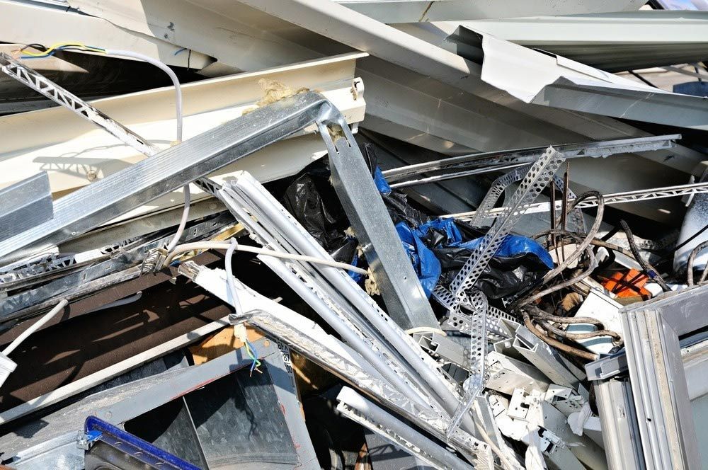 A Pile of Scrap Metal Is Sitting on Top of Each Other — H & H Metal Recycling In Maroochydore, QLD
