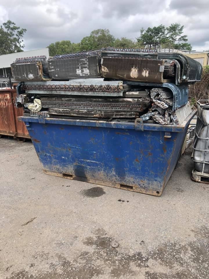 Blue Dumpster Filled With Discarded Air Conditioner Coils — H&H Metal Recycling in Caloundra West, QLD