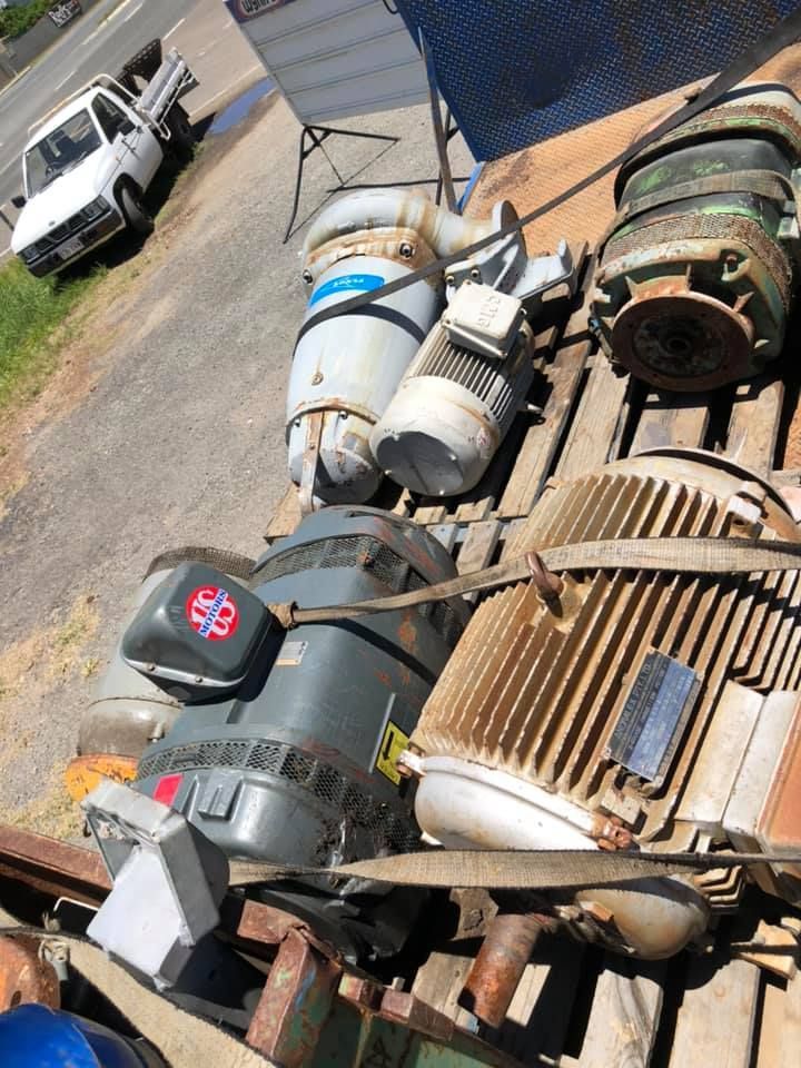 A Wooden Pallet Holds Various Industrial Electric Motors — H&H Metal Recycling in Caloundra West, QLD