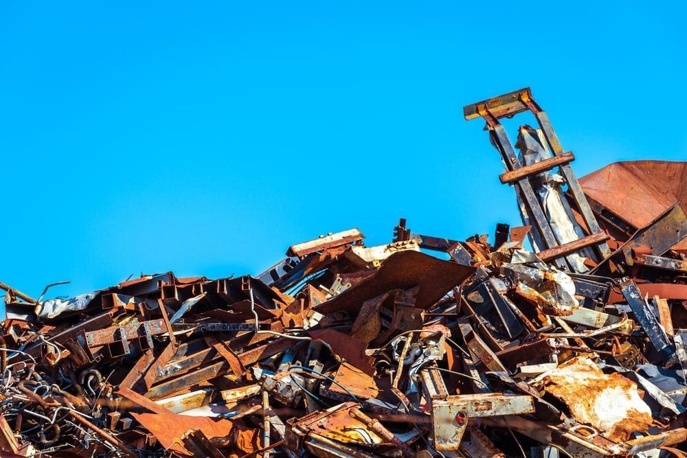 A Pile of Scrap Metal with A Blue Sky in The Background — H & H Metal Recycling In Nambour, QLD