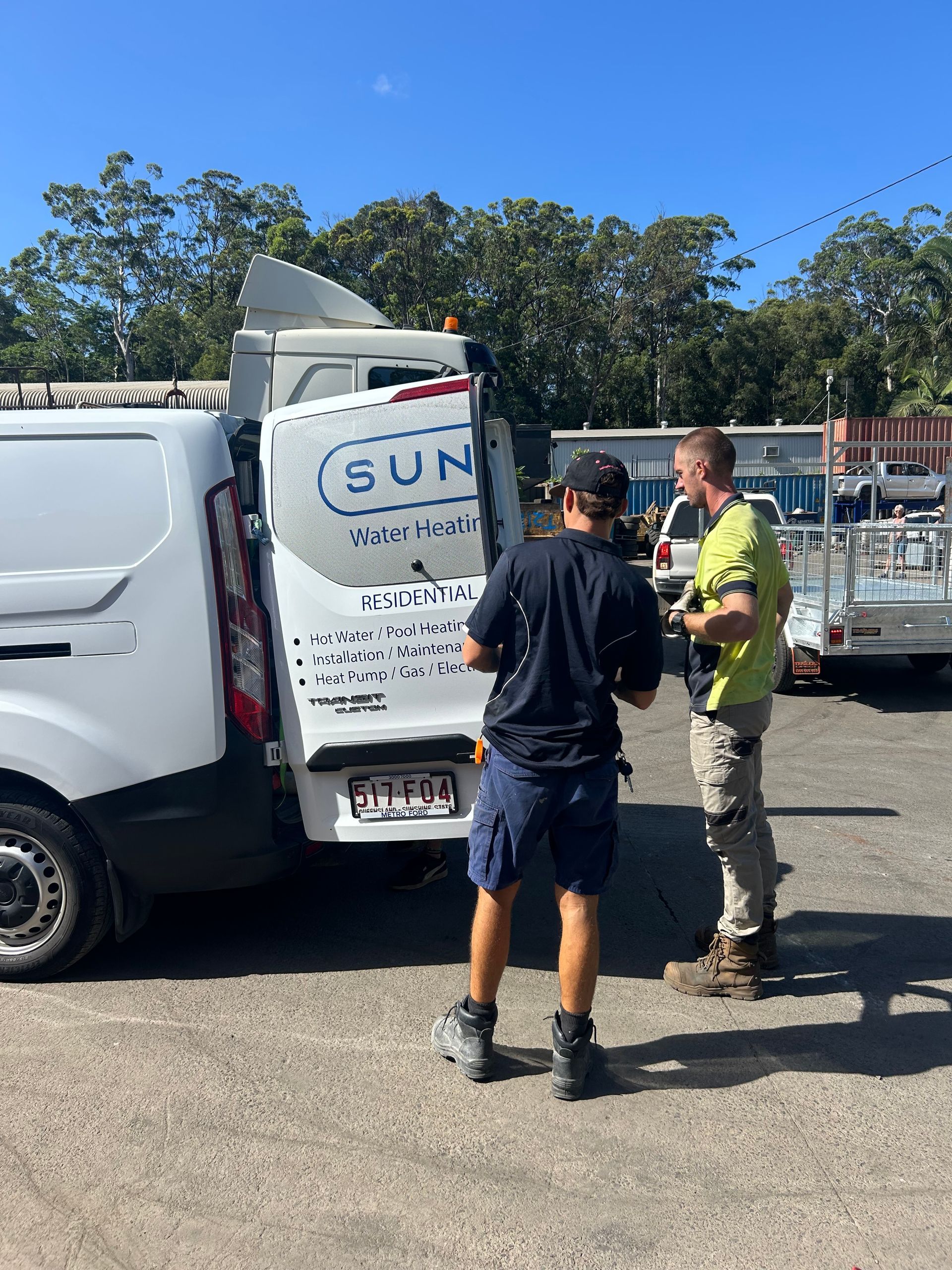 Two Technicians in Work Clothes Stand at the Open Back Doors — H&H Metal Recycling in Bells Creek, QLD