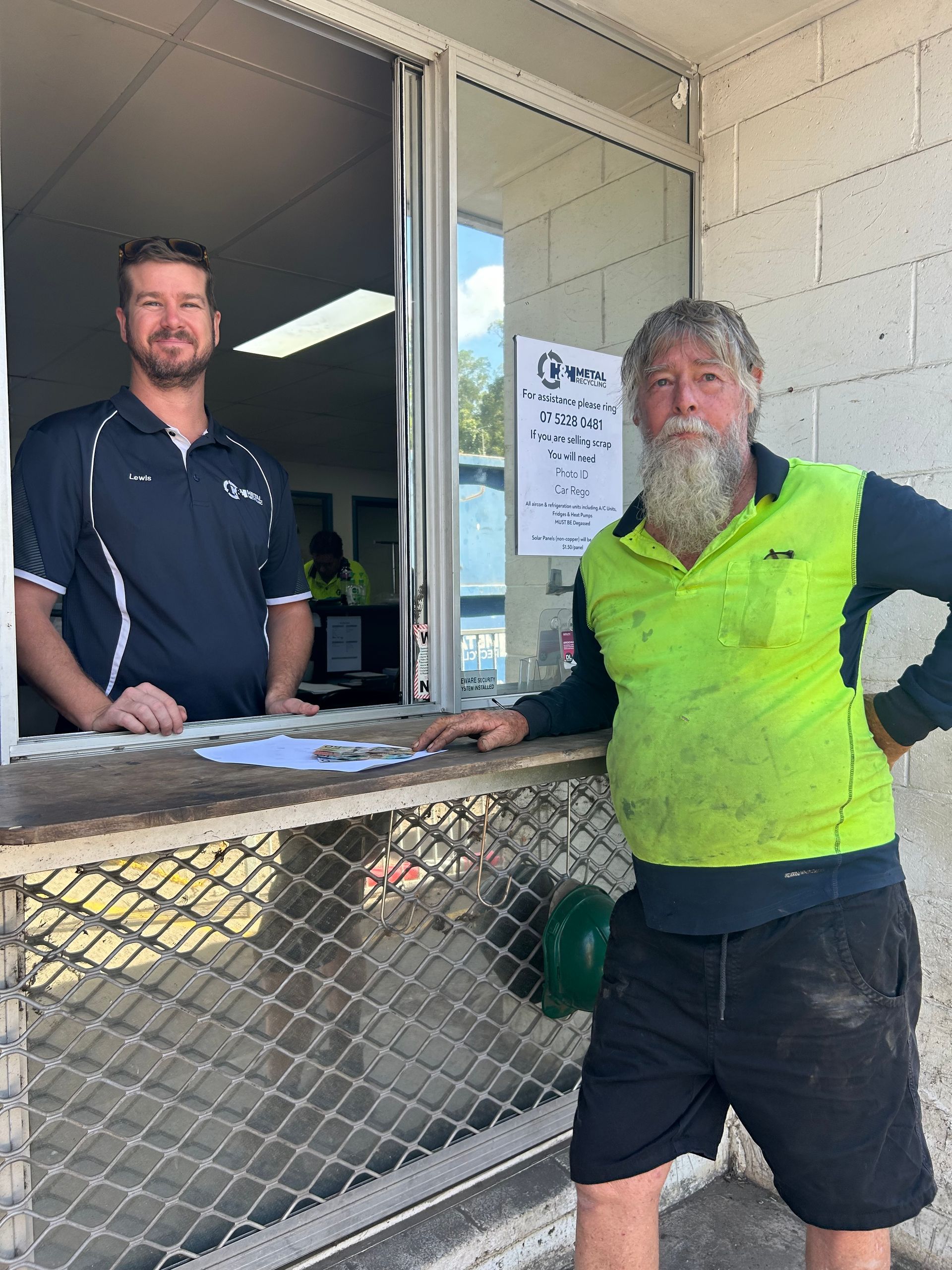 Two Men Stand at a Service Window — H&H Metal Recycling in Moffat Beach, QLD